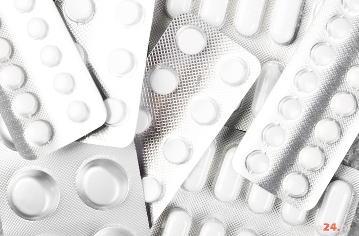 Pills. Medicine Pills in blister pack on grey background. Tablets and bottle. Copy space